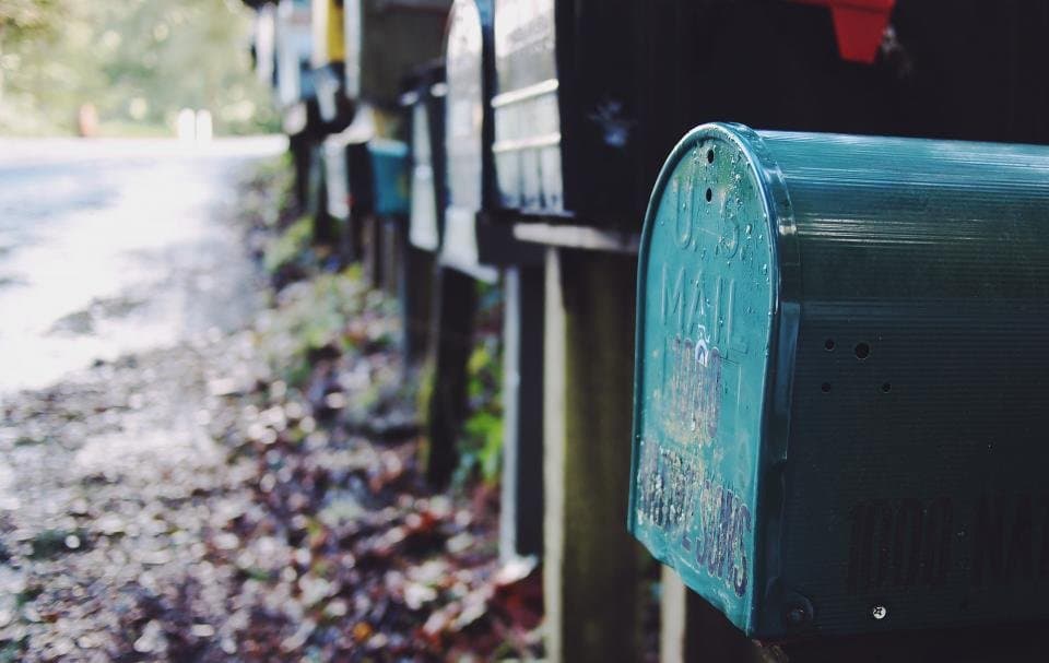 A row of mailboxes along a quiet street.